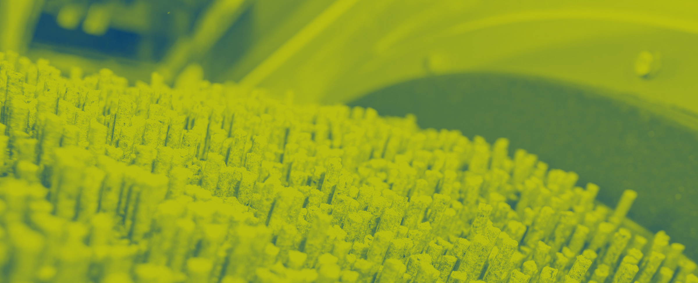 Image of feed pellets coming out of a pellet mill die