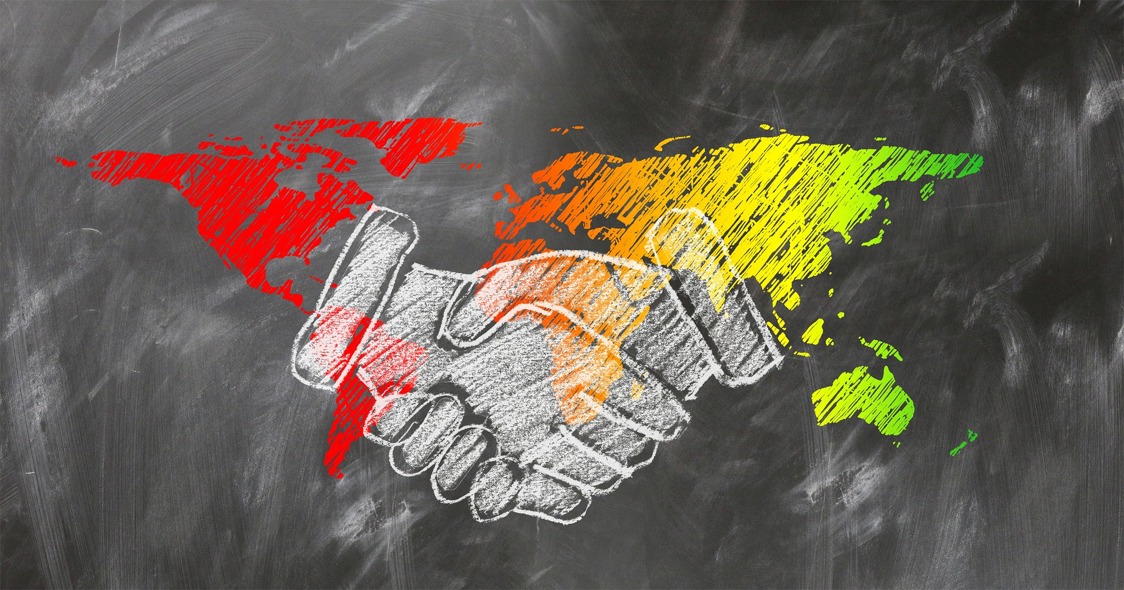 shaking hands on world map